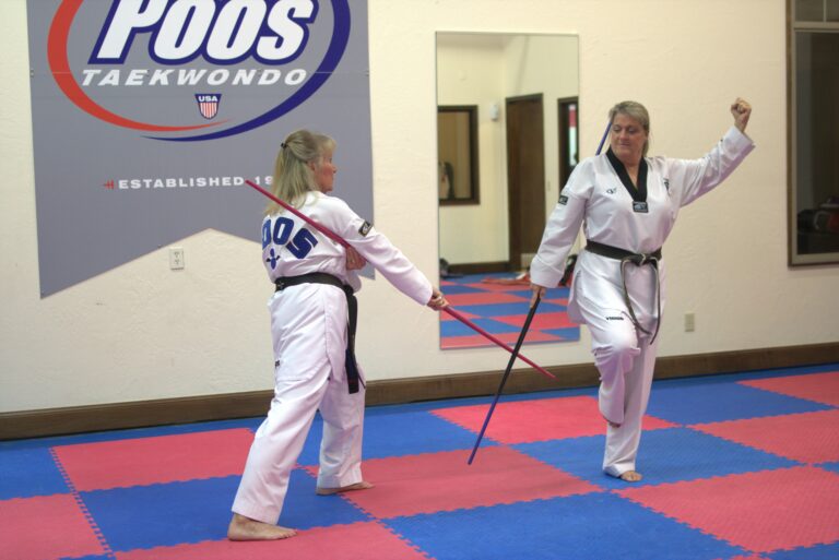 Two women in taekwondo uniforms